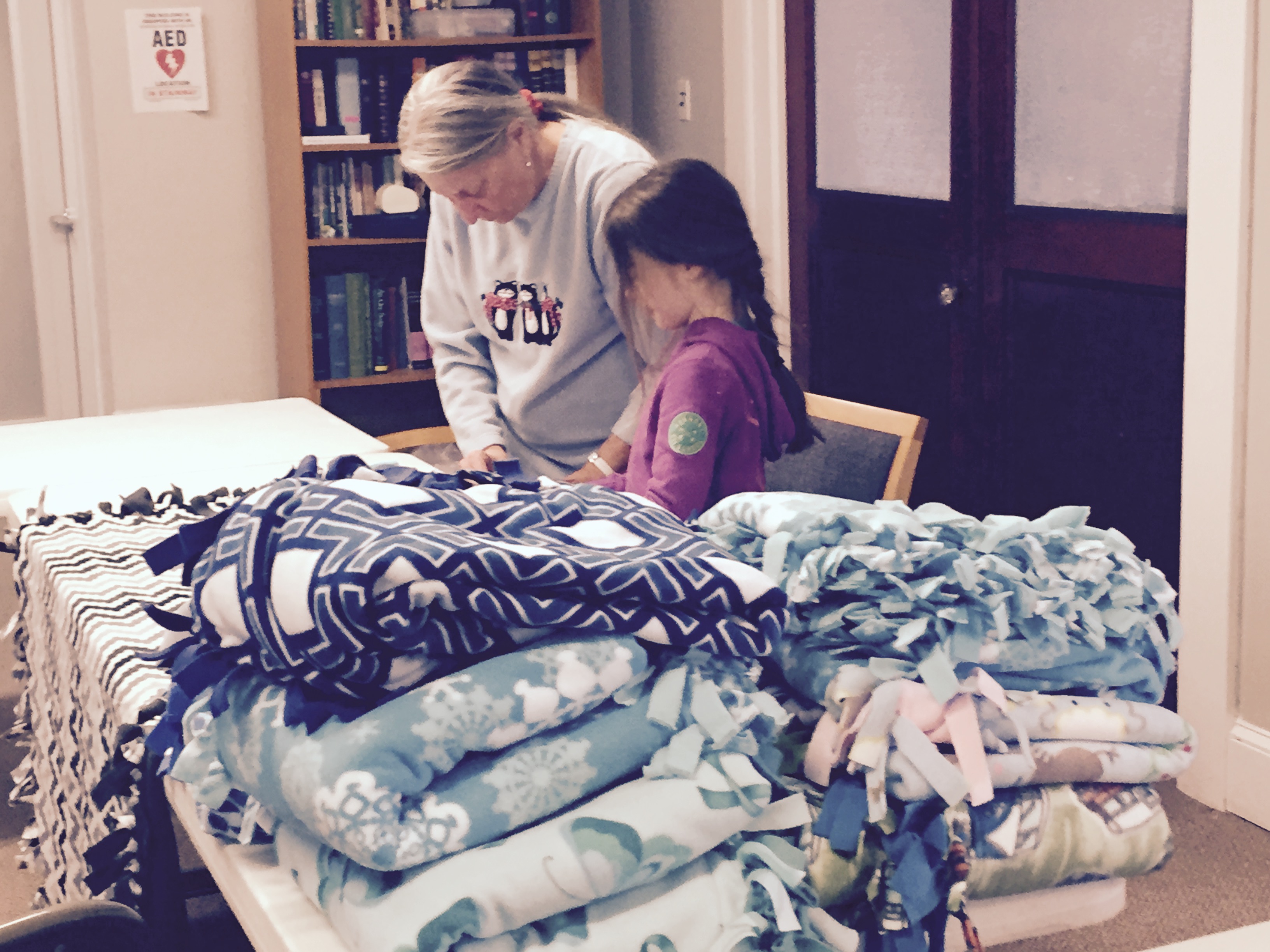 Volunteers prepare the blankets for delivery to those in need.